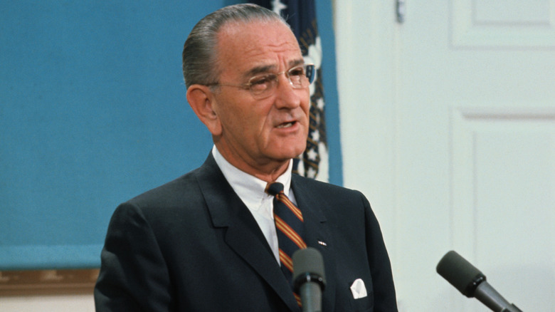 Present Lyndon B. Johnson speaking at the White House