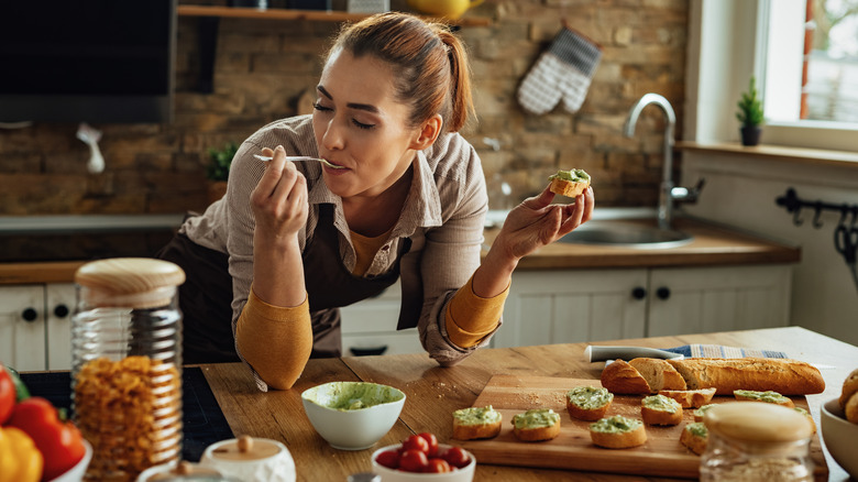 Woman eating bruschetta with guacamole 