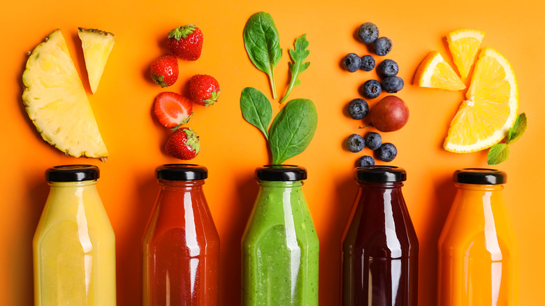 bottles of juice with orange background