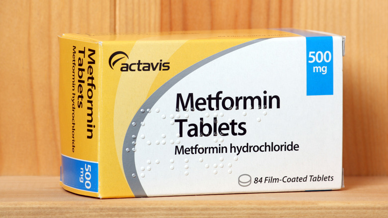 Box of metformin tablets on a wooden shelf