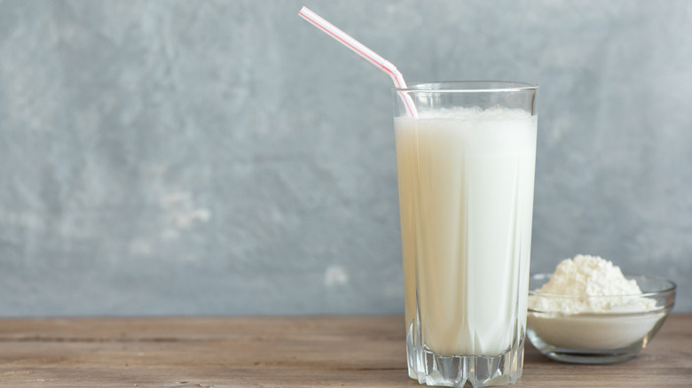 whey protein in a glass with straw