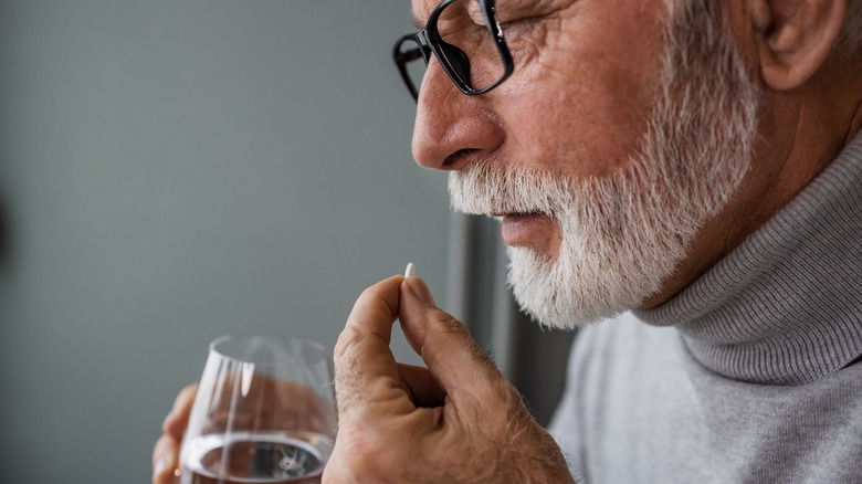 Senior man taking medication