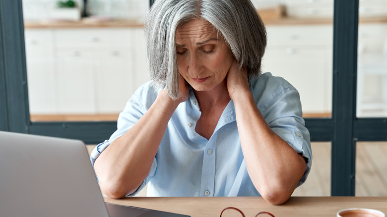 woman at desk in pain