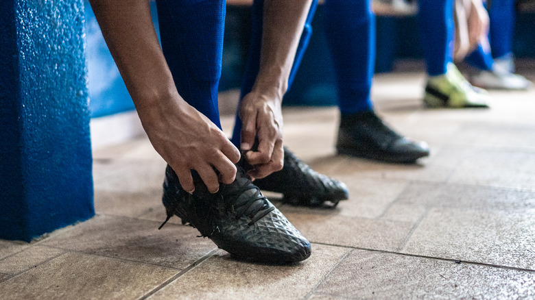 Athlete tying shoes preparing to run