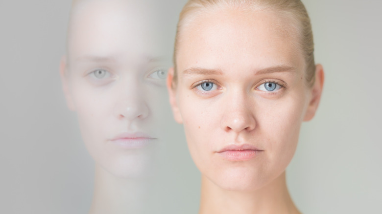 woman with duplicate on grey background