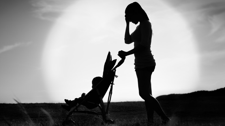 woman pushing baby in stroller 