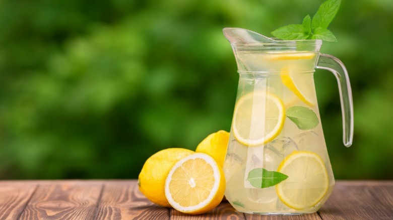 pitcher of water with lemons and limes