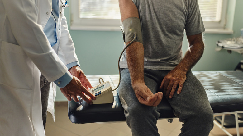 Person getting their blood pressure checked by doctor