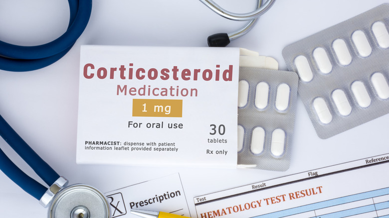 Corticosteroid medication in blister packets with doctor's materials