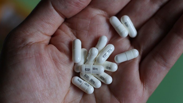 A hand holding gabapentin tablets