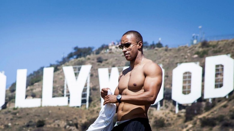 Kollins Ezekh standing in front of the Hollywood sign