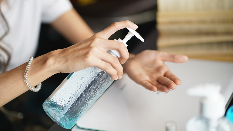 woman pumping hand sanitizer