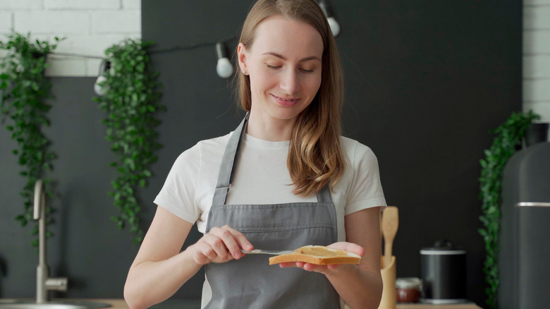 Woman making a peanut butter sandwich