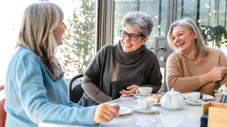 Mature women eating a meal together