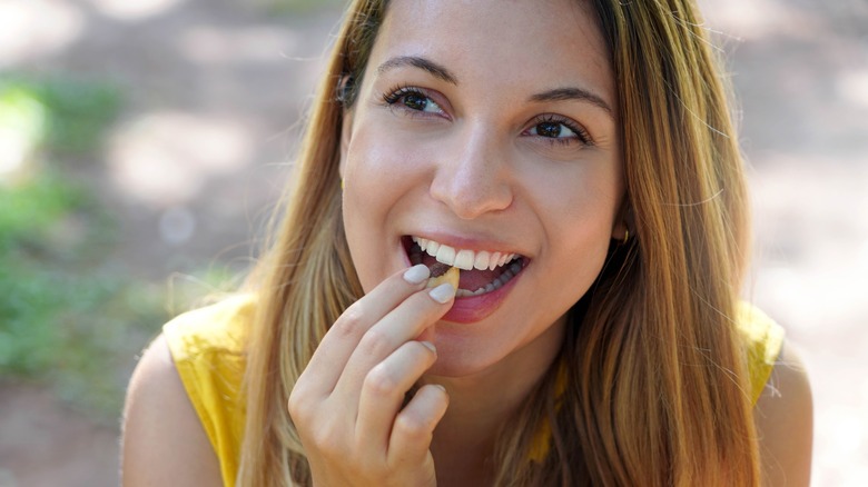 Woman eating Brazil nuts