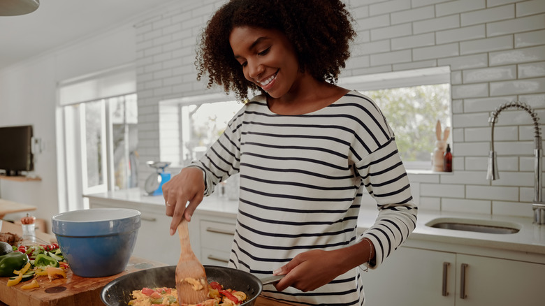 Woman making dinner in her kitchen