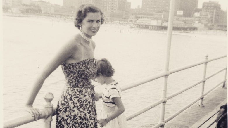Old black and white photo of Dr. Eger and her daughter standing at a railing