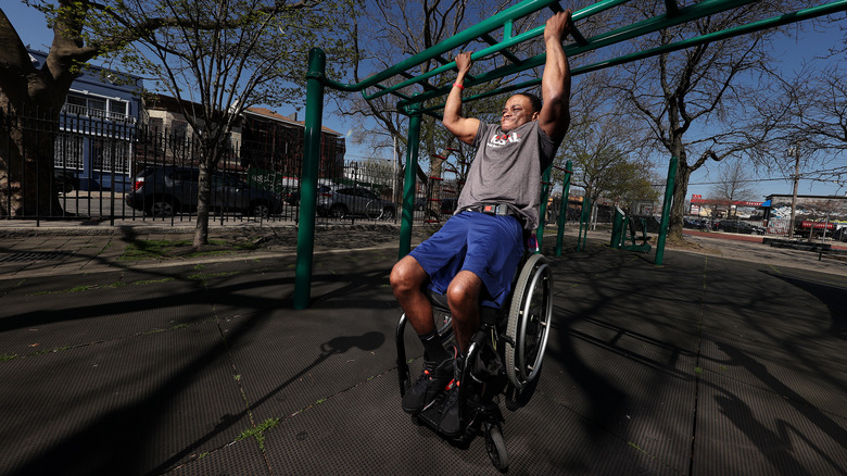 Paralympic athlete Garrison Redd performs a pull-up