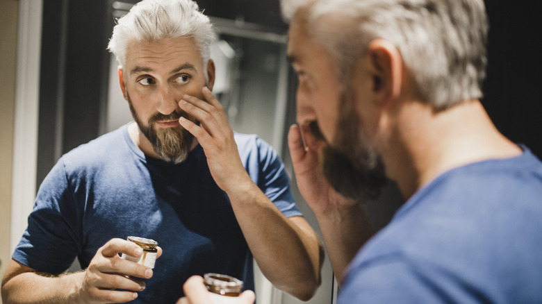 Man applying under-eye cream