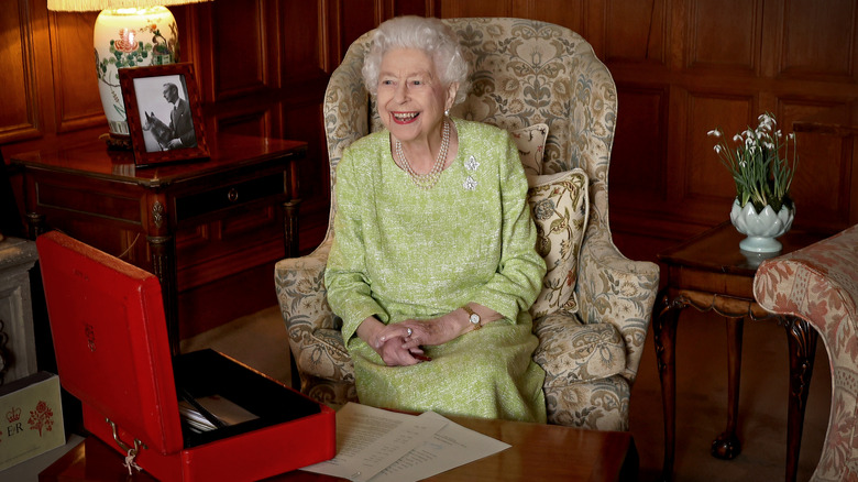 Queen Elizabeth sitting at desk