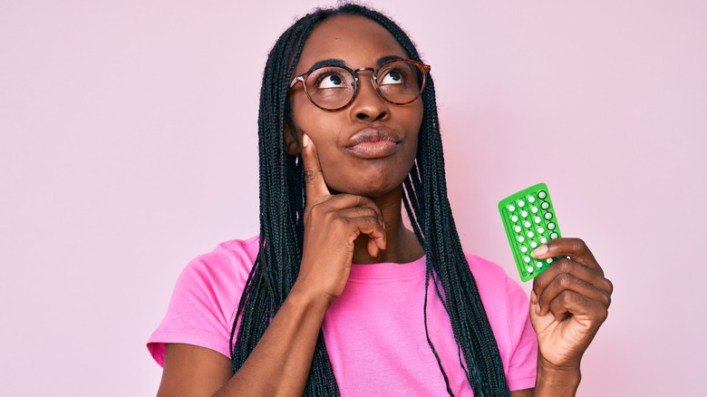 woman thinking about the pill