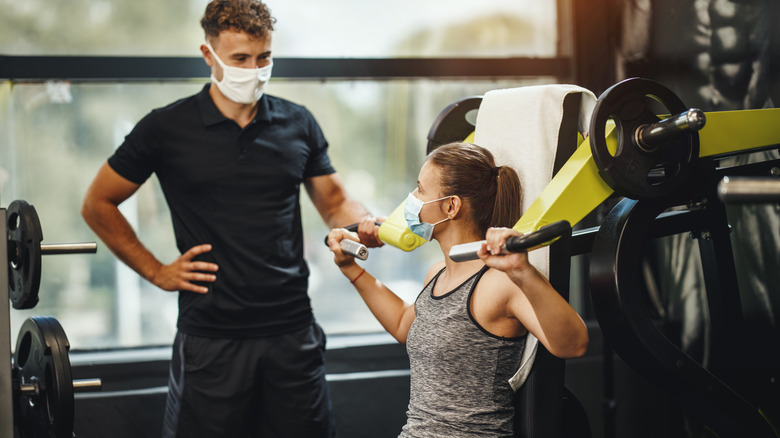 Trainer and client speaking inside gym