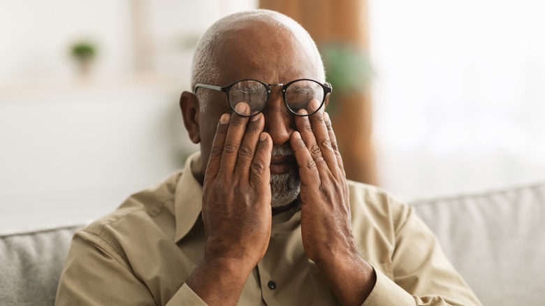 Man experiencing eye pain