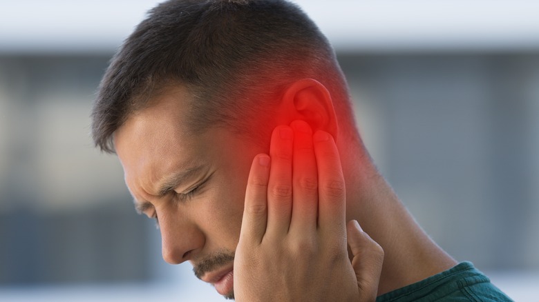 Man experiencing ear pain