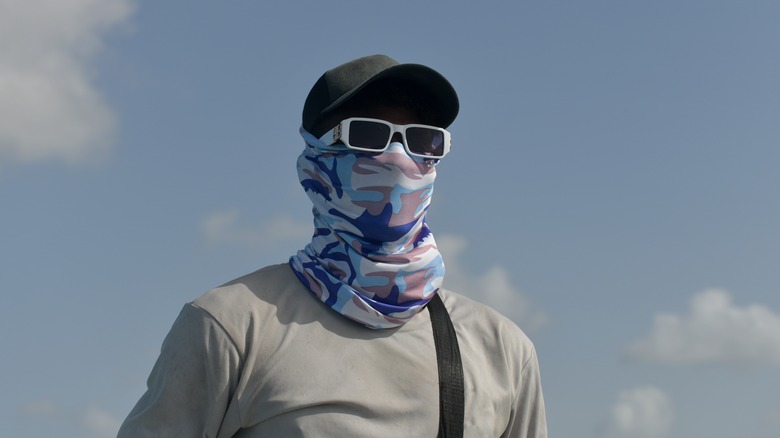 Man wearing sun-protective clothes