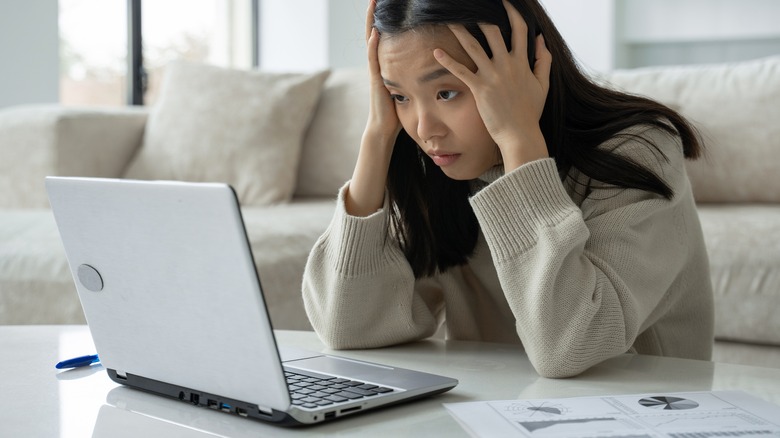 young woman stressed out on computer