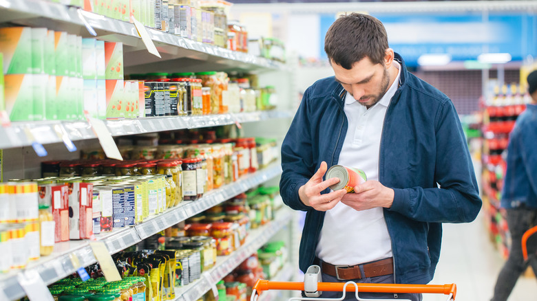 man looking at food label