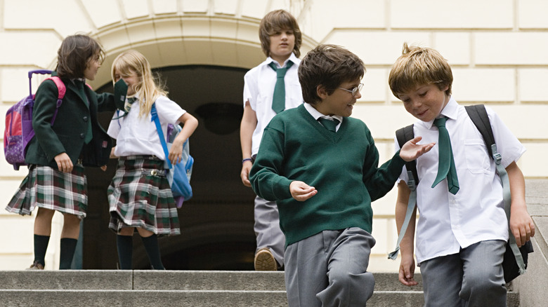 children talking to one another on school steps