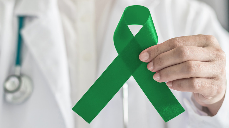 doctor holding tourette's ribbon