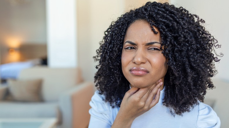 woman holding tonsils