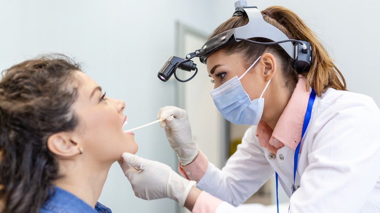 doctor checking patient's strep throat