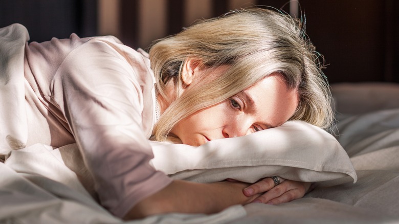 woman in bed unable to sleep
