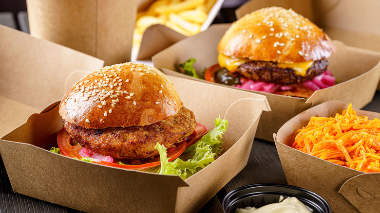 Several burgers in boxes