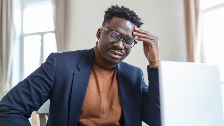 Man at desk in pain