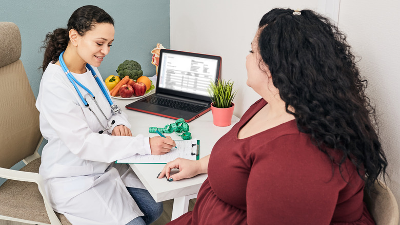 obese woman meeting with dietician