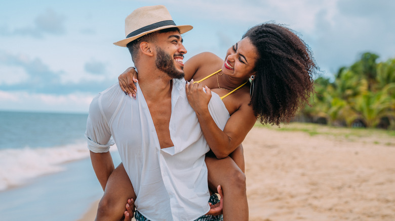 happy couple on a beach during their honeymoon