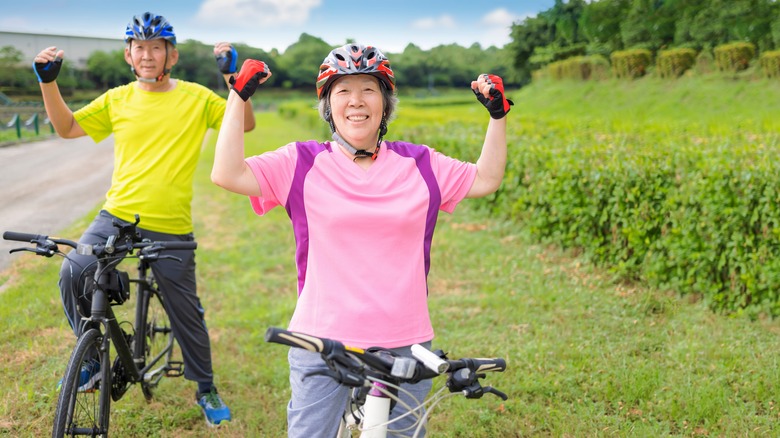 elderly couple on bikes