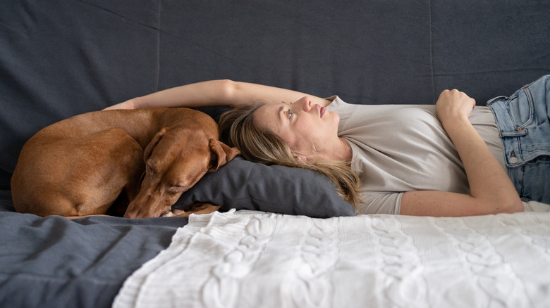 Woman laying with dog