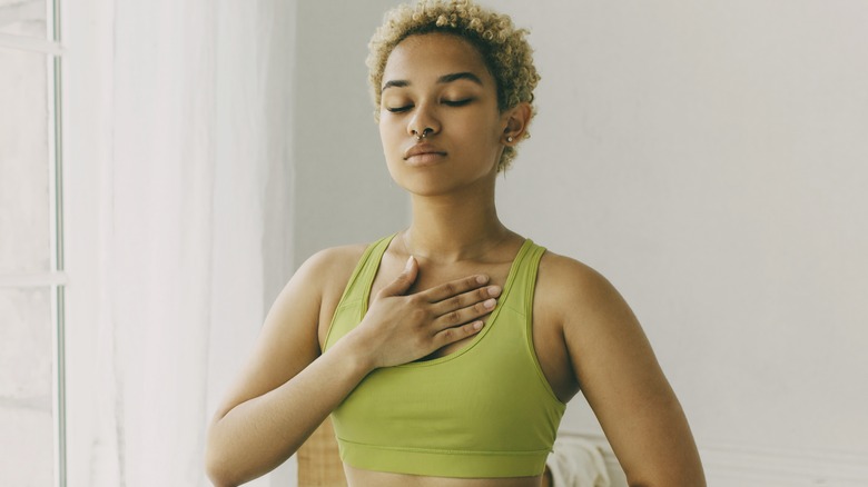 Woman breathing with hand on chest