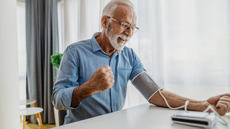 older man celebrating good blood pressure reading