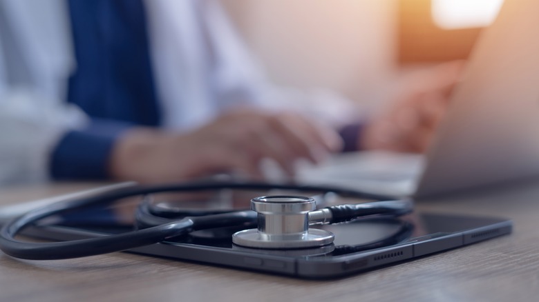 doctor working on tablet desk