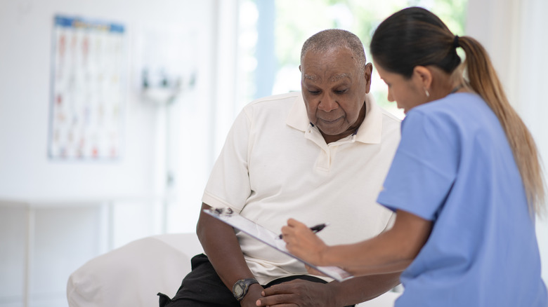 nurse talking to male prostate cancer patient