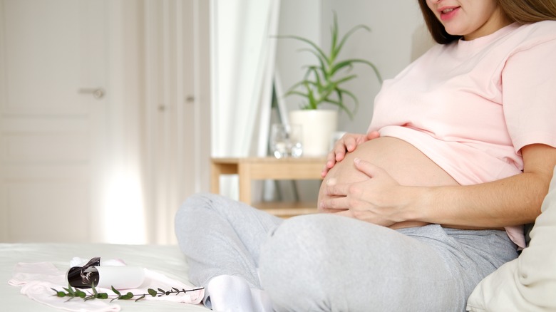 Pregnant woman stroking her belly