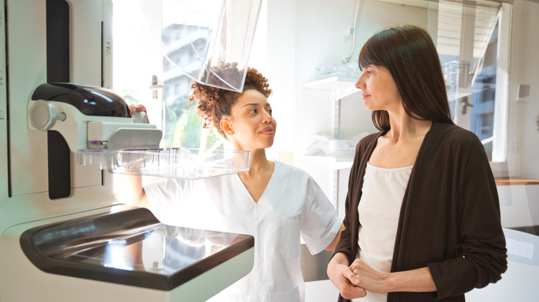 Woman talking to doctor before getting a mammogram