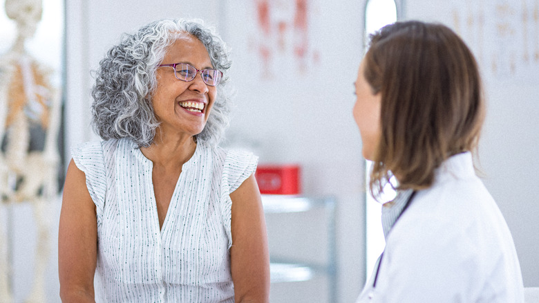 Smiling woman talking to her doctor