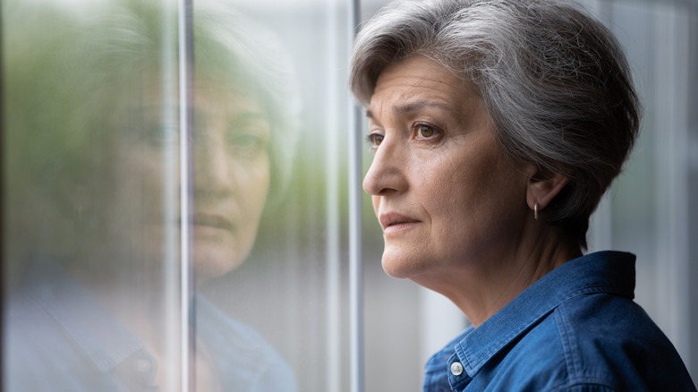 woman looking out a window